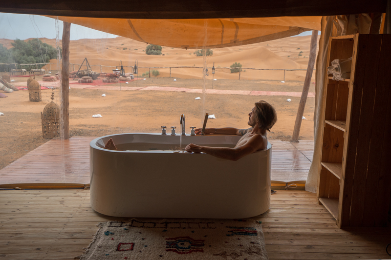 Enjoying a bath in from of the Sahara desert in a luxury glamping tent
