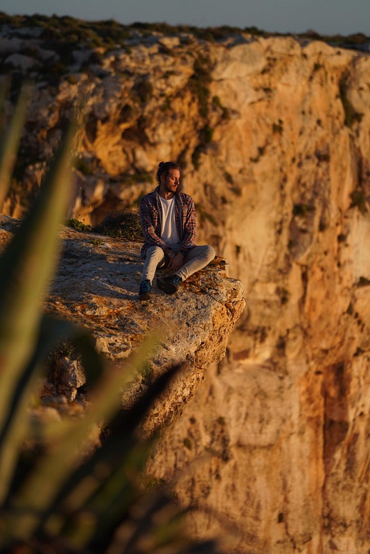 Man on the edge of a cliff above the sea (1)